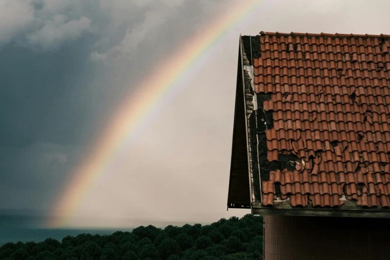 a rainbow is in the sky over a roof, an album cover, inspired by Elsa Bleda, pexels contest winner, renaissance, demolition, 1990's photo, high quality wallpaper, abandoned cottage