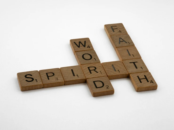 wooden scrabbles spelling words on a white surface, a mosaic, by Daniel Lieske, unsplash, faith, soaring, spirits, 1 6 x 1 6