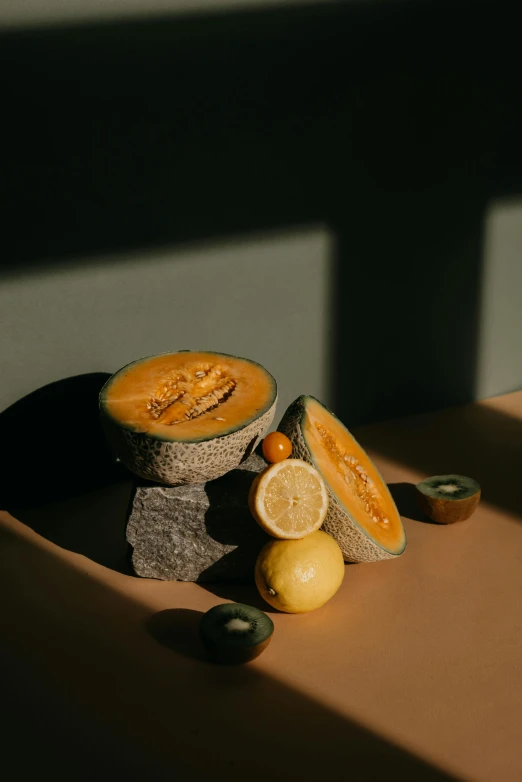 a cut up melon sitting on top of a table, a still life, inspired by Elsa Bleda, unsplash contest winner, made of glowing wax and ceramic, ignant, smooth solid concrete, suns