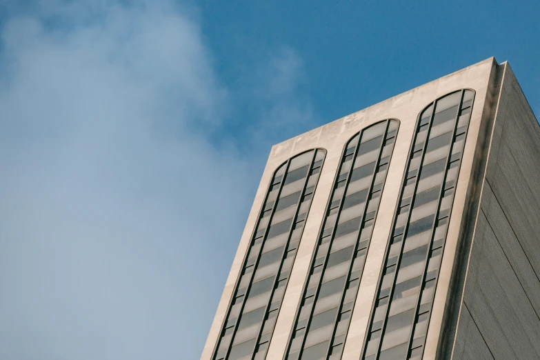 a tall building with a clock on top of it, inspired by Richard Wilson, unsplash, brutalism, clear blue skies, brown, thumbnail, grey