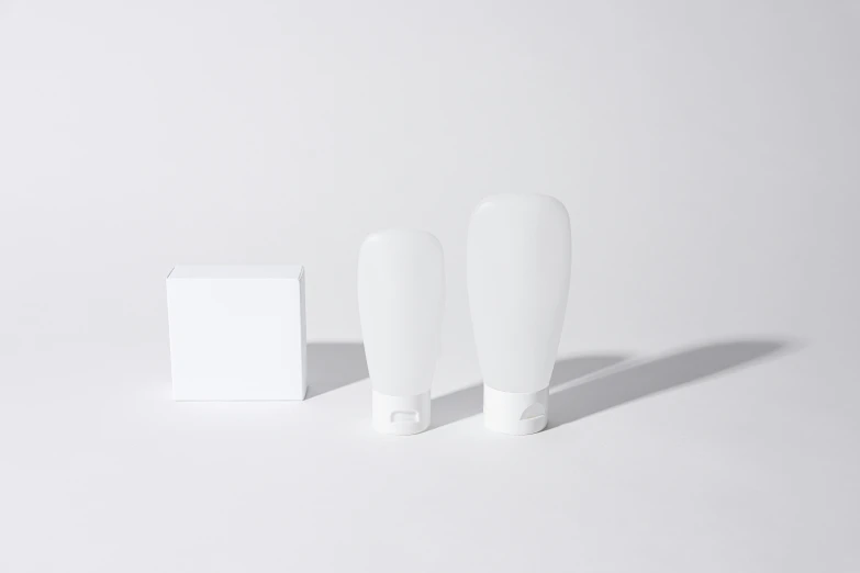 a couple of toothbrushes sitting next to a box of toothpaste, by Shigeru Aoki, silicone cover, light bulb, product introduction photo, white color scheme