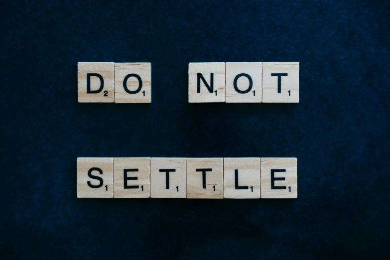 the words do not settle spelled in scrabbles on a blue background, pexels, sots art, on a gray background, sustainable, settlement, slate