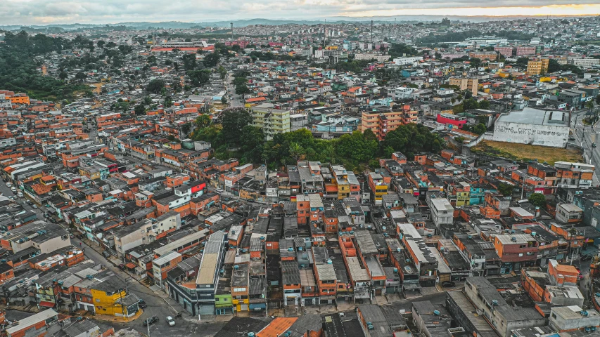 an aerial view of a city with lots of buildings, an album cover, pexels contest winner, location ( favela ), panoramic, brown, neighborhood