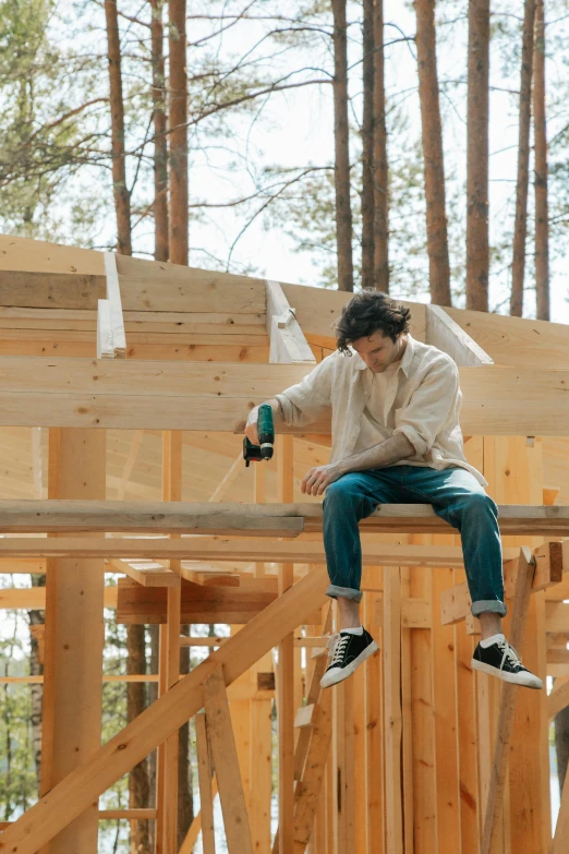 a man sitting on top of a wooden structure, profile image, glue dropping, cottagecore, bulky build