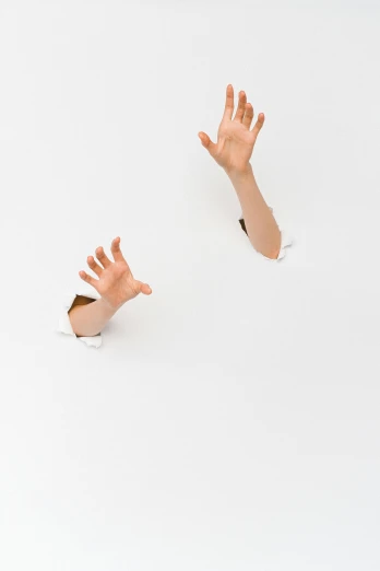 two hands reaching out of a hole in a sheet of paper, an album cover, inspired by Cornelia Parker, unsplash, conceptual art, ron mueck, ignant, crash landing, white sleeves