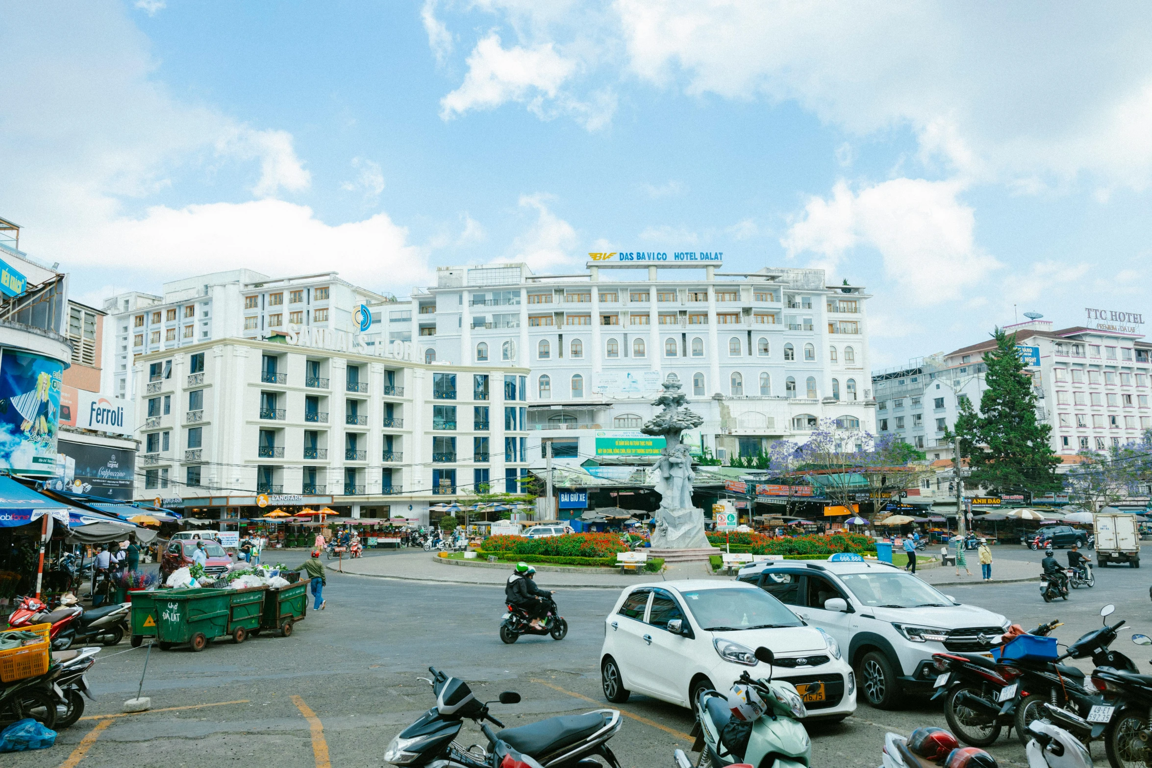 a group of motorcycles parked in a parking lot, unsplash, art nouveau, vietnam, white marble buildings, square, medical complex