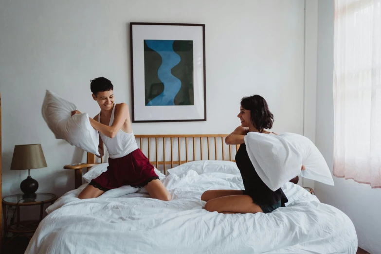 a couple of people that are on a bed, by Julia Pishtar, pexels contest winner, happening, lesbian, throw, listing image, sasai ukon masanao