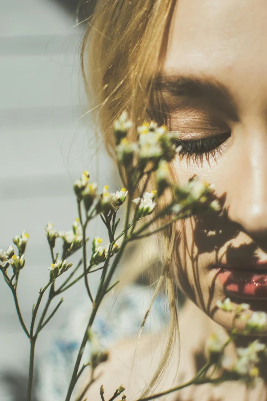 a close up of a person holding a flower, inspired by Elsa Bleda, trending on unsplash, aestheticism, portrait of a blonde woman, long lashes, woman made of plants, profile image