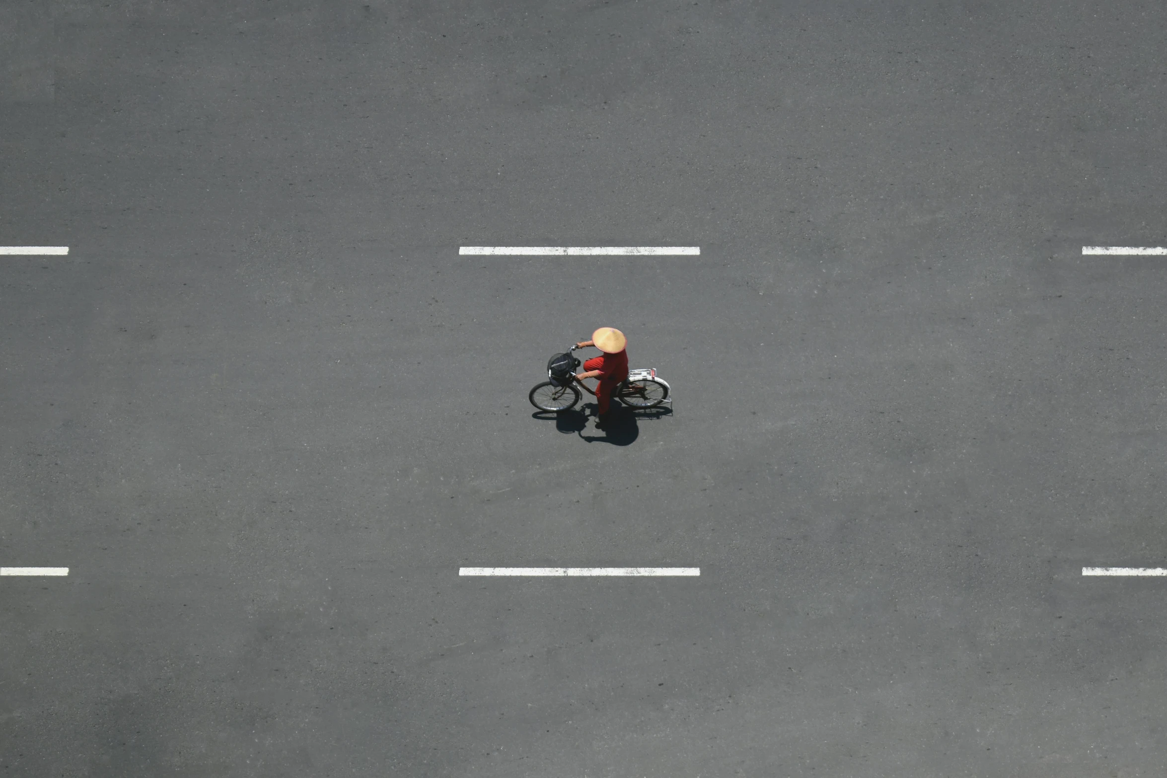 a person riding a motorcycle down a street, a minimalist painting, by Shang Xi, pexels contest winner, postminimalism, drone photograpghy, little kid, parking lot, traffic police woman