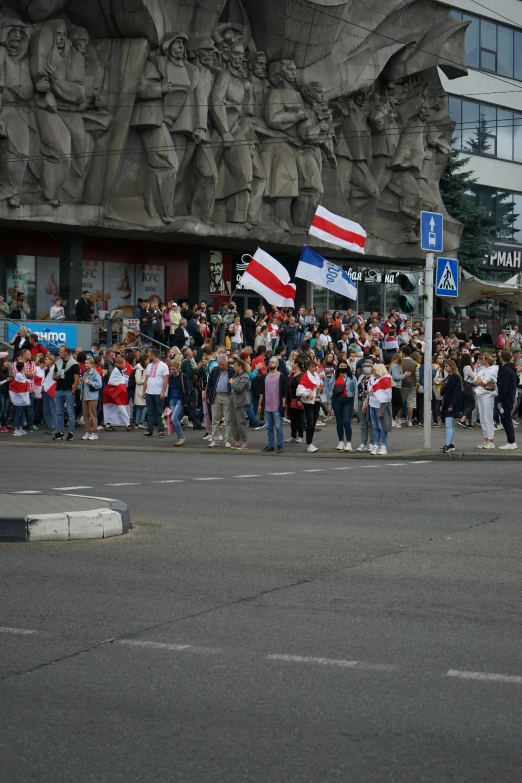 a group of people that are standing in the street, by Attila Meszlenyi, happening, flags, low quality photo, slavic!!!, fans