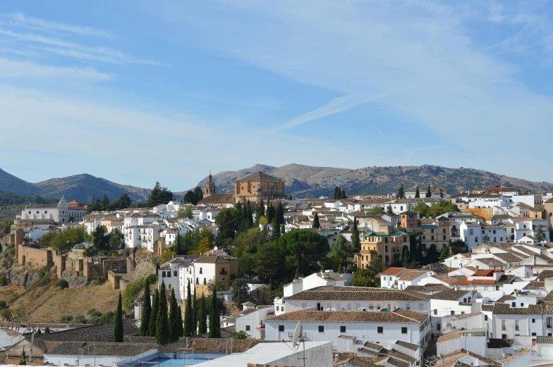 a view of a town from the top of a hill, by Alejandro Obregón, pexels contest winner, renaissance, moorish architecture, slightly sunny, white, rusty