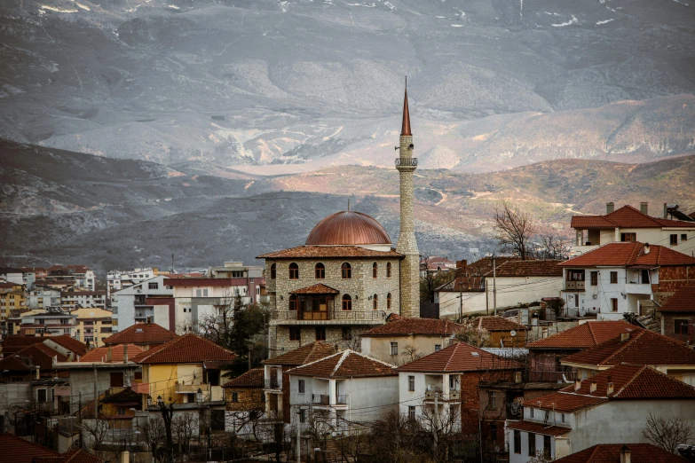 a view of a town with mountains in the background, inspired by Edi Rama, pexels contest winner, mosque, byzantine, grey, square