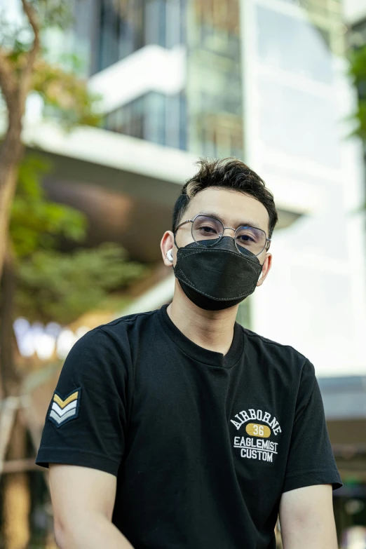 a man sitting on a motorcycle wearing a face mask, wearing black tshirt, post graduate, david luong, detailed face with mask