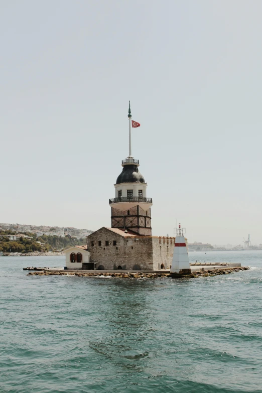 a lighthouse in the middle of a body of water, istanbul, slightly sunny, 2022 photograph, fan favorite