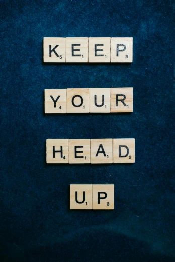 scrabbles spelling keep your head up on a blue background, an album cover, by Jesper Knudsen, unsplash, happening, portrait n - 9, business, bedhead, covid