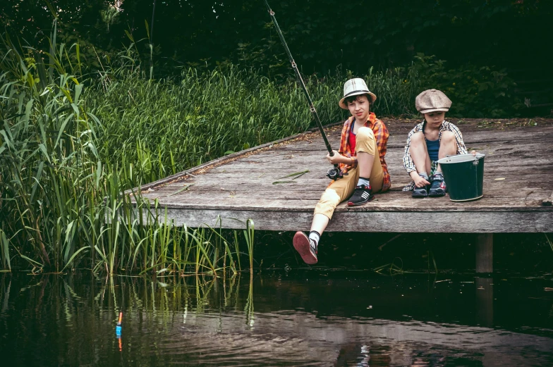 a couple of kids sitting on top of a wooden dock, by Lee Gatch, pexels contest winner, fishing, in a pond, fisherman's hat, cardboard