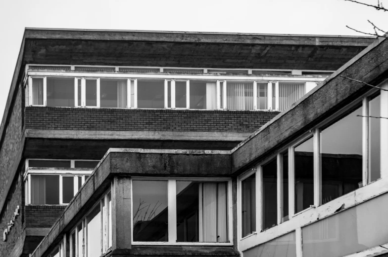 a black and white photo of a building, unsplash, brutalism, elstree, 1 9 7 0 s photo, windows, 1970s photo