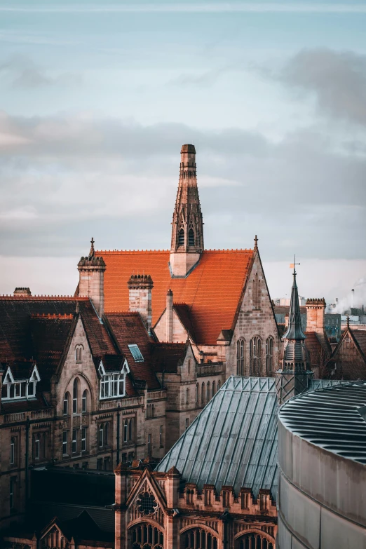 a view of a city from the top of a building, by IAN SPRIGGS, pexels contest winner, renaissance, orange roof, gothic building style, outside the'school of magic ', exterior