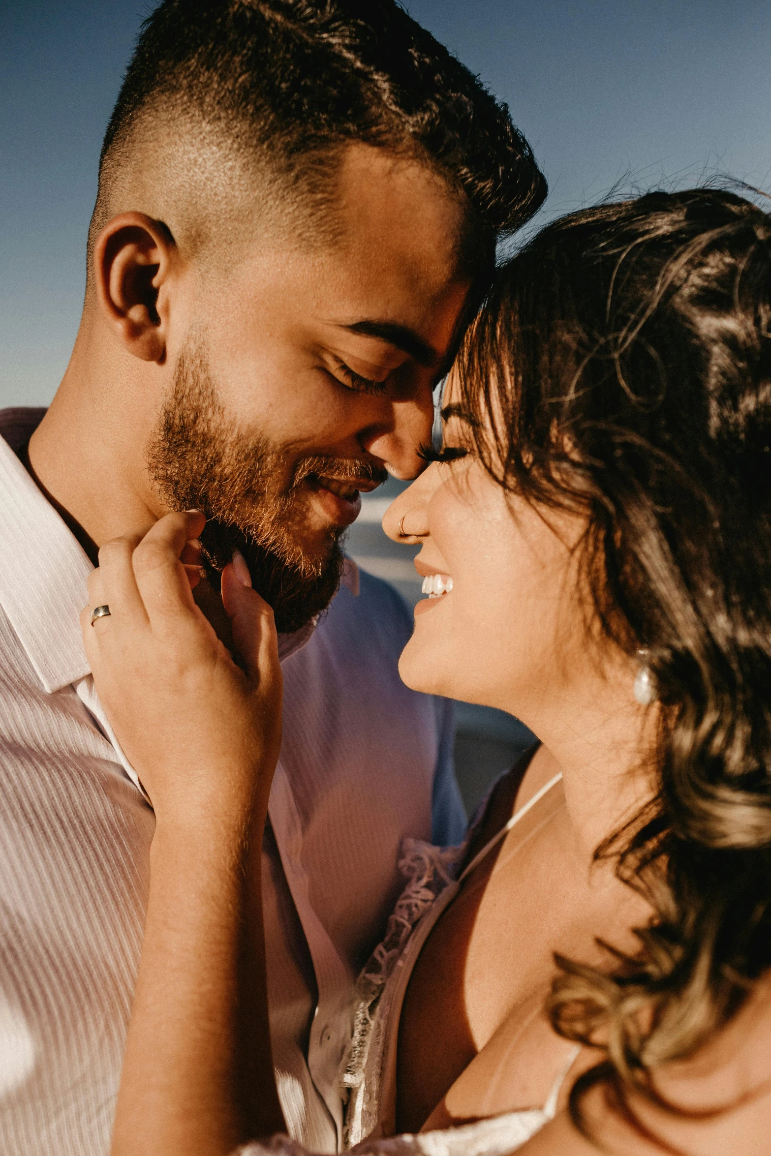 a man and woman standing next to each other on a beach, pexels contest winner, romanticism, closeup headshot, hispanic, kissing smile, thumbnail