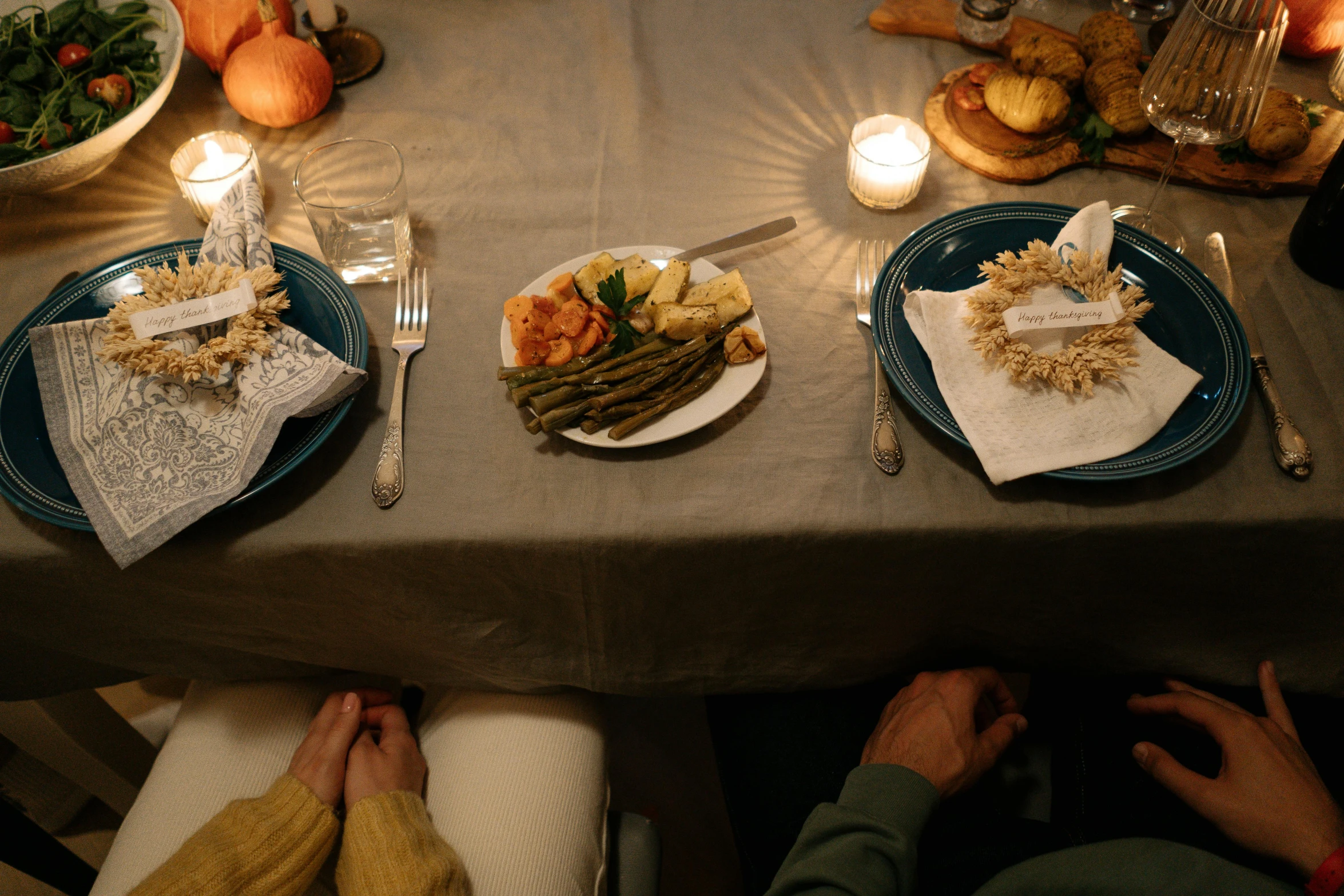a couple of people sitting at a table with plates of food, by Carey Morris, pexels contest winner, renaissance, natural candle lighting, harvest, middle of the night, 15081959 21121991 01012000 4k