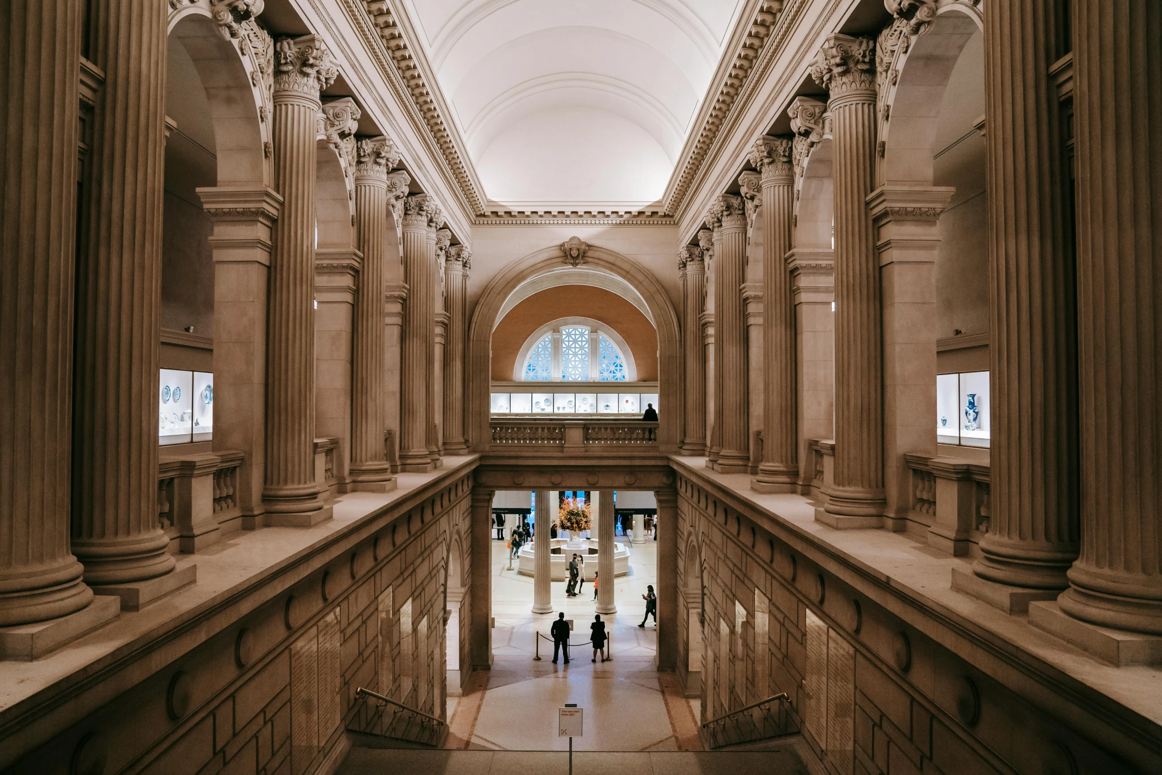 a couple of people that are standing in a building, unsplash contest winner, neoclassicism, the metropolitan museum of art, gif, a busy arcade, overview