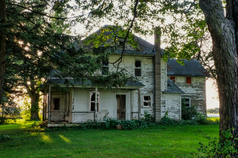 a large white house sitting on top of a lush green field, a portrait, inspired by Gregory Crewdson, flickr, photo of poor condition, yellowed with age, exterior photography, background image