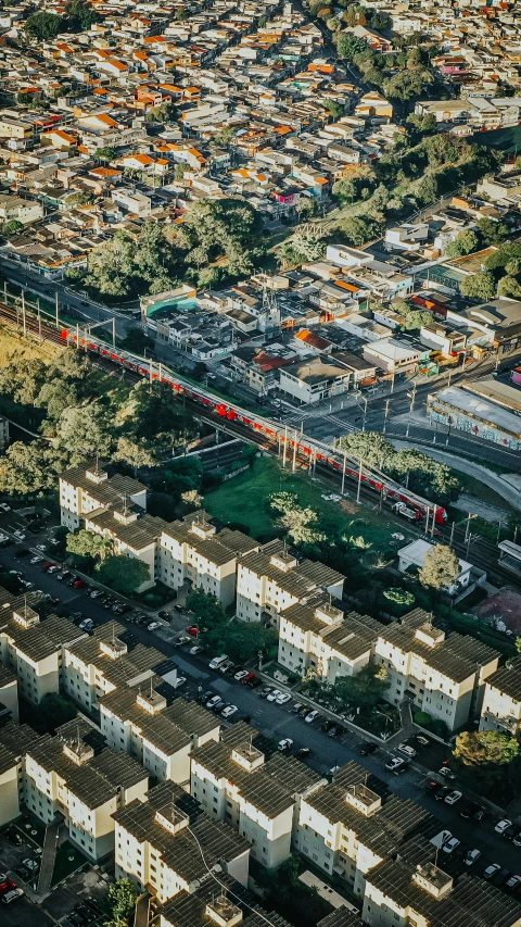 an aerial view of a city with lots of buildings, by Alejandro Obregón, pexels contest winner, photorealism, train far, suburbia, são paulo, overpass