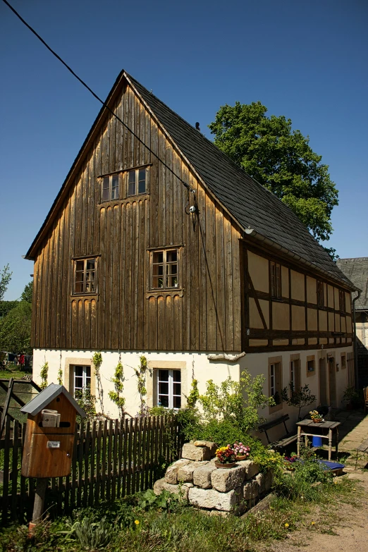 a couple of houses that are next to each other, a picture, by Karl Hagedorn, flickr, renaissance, barn in background, square, very sunny, germany. wide shot