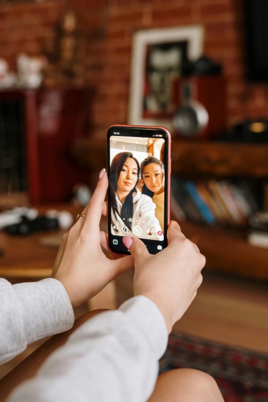 a woman taking a picture of herself with her cell phone, a picture, trending on pexels, family photo, with long, tiktok video, center frame medium shot