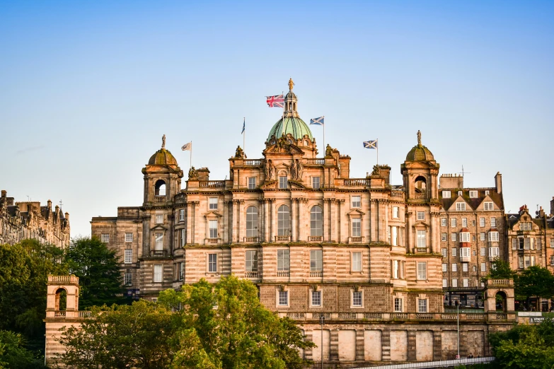 a large building with a clock on top of it, scottish, at golden hour, square, coloured