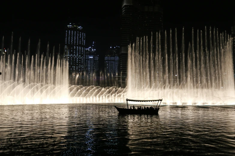 a boat that is sitting in the water, by Bernardino Mei, pexels contest winner, hurufiyya, fountains, gta : dubai, promo image, video still