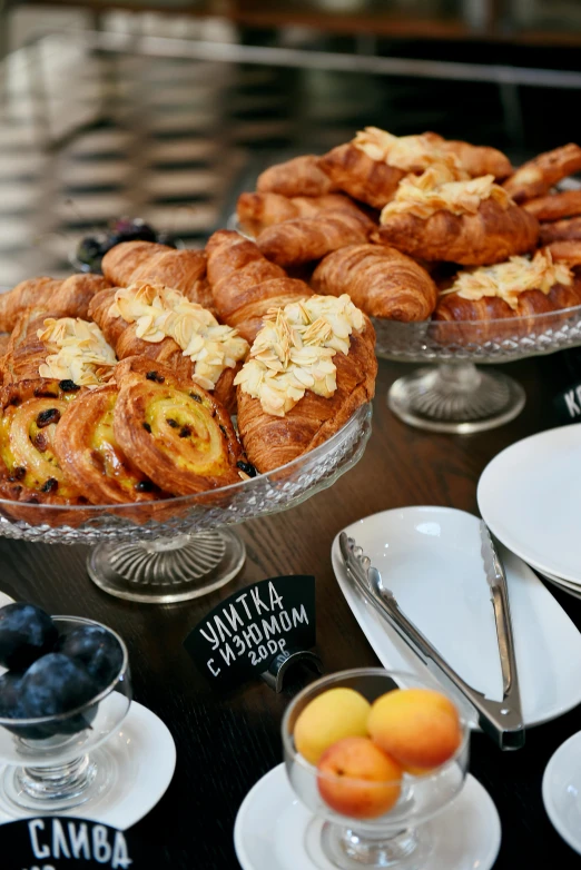 a table topped with lots of different types of pastries, by Nina Hamnett, unsplash, baroque, breakfast buffet, helsinki, award-winning crisp details”, vista view