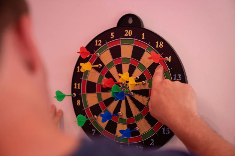 a man is playing a game of darts, a cartoon, pexels contest winner, children's toy, magnetic, wall art, “the ultimate gigachad