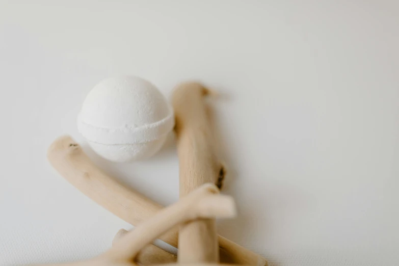 a white bath ball sitting on top of a wooden rack, a marble sculpture, unsplash, white background : 3, bones joints, person made of tree, powder