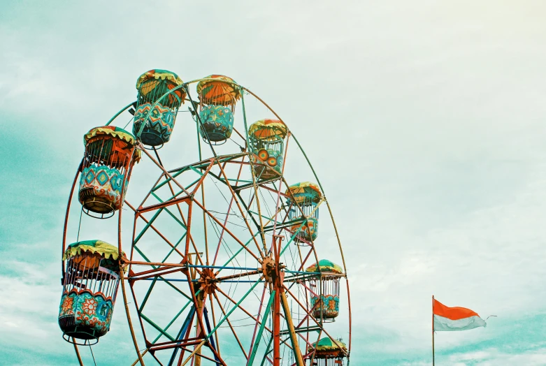 a ferris wheel sitting on top of a lush green field, a colorized photo, pexels contest winner, aestheticism, turquoise and orange, cotton candy, temple fair, 🦩🪐🐞👩🏻🦳