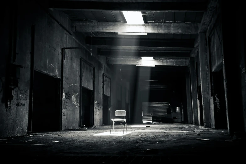 a chair that is sitting in the middle of a room, pexels contest winner, light and space, abandoned night hangar, instagram photo, grey warehouse background, horror scene