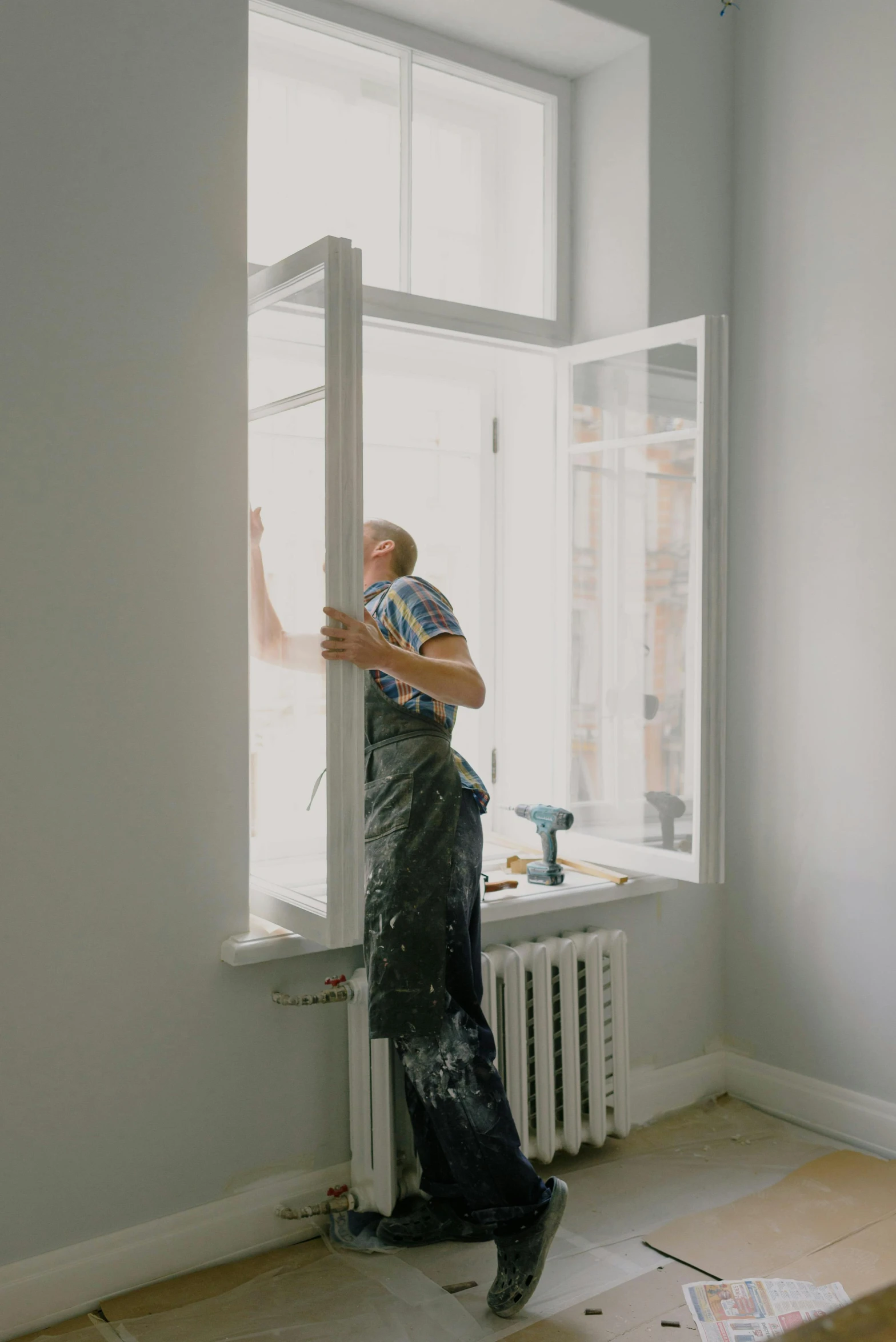 a man that is standing in front of a window, under repairs, profile image, average, indoor picture