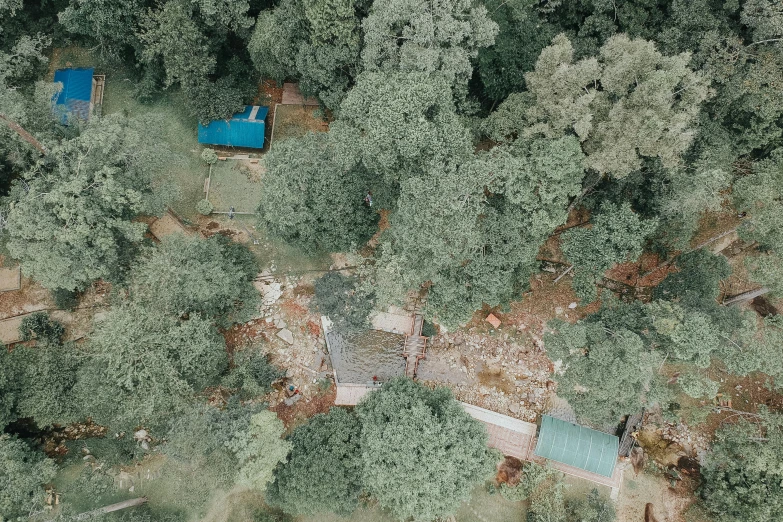 a bird's eye view of a house in the woods, hurufiyya, adventure playground accident, landslides, bodies on the ground, image from afar