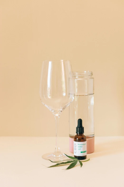 a bottle of essential oil next to a glass of wine, unsplash, clear shapes, high resolution product photo, assemble, 3/4 front view