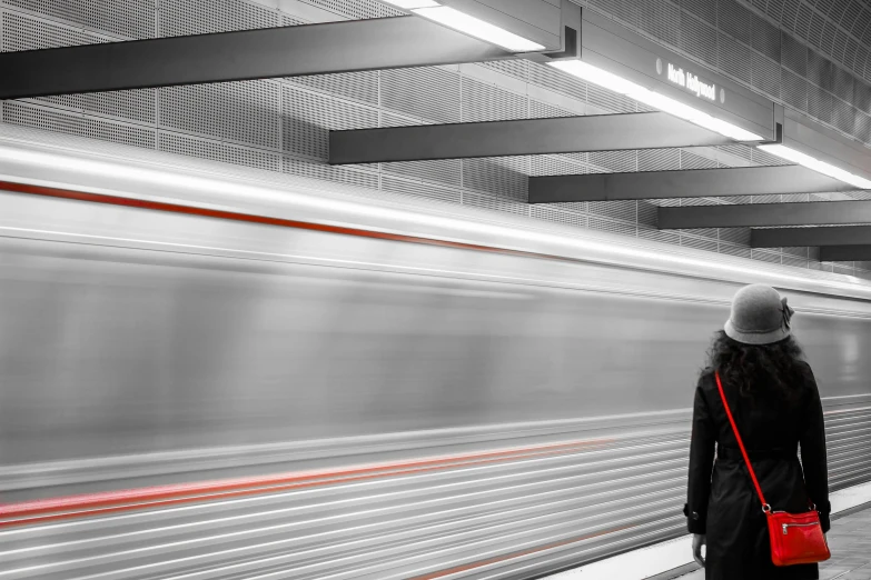 a woman waiting for a train at a subway station, a digital rendering, by Kurt Roesch, pexels contest winner, minimalism, long exposure ; sharp focus, red black and white, hyperspeed, screensaver