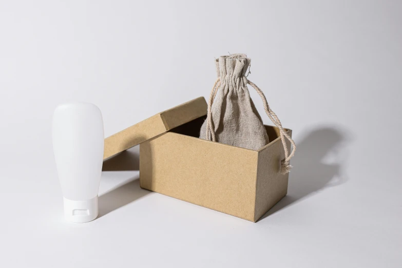 a white toothbrush sitting inside of a brown box, by Eden Box, holding a lantern, asset on grey background, bottle, fully covered