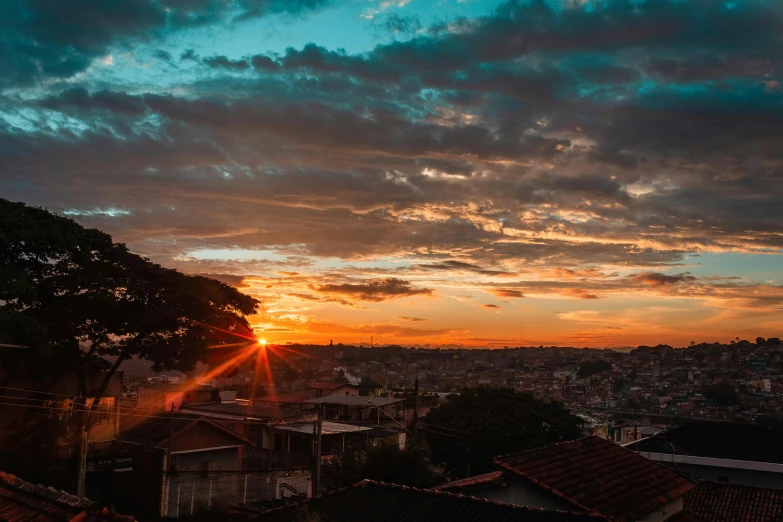 a view of the sun setting over a city, by Daniel Lieske, pexels contest winner, brazilian, panorama view of the sky, neighborhood, summer setting