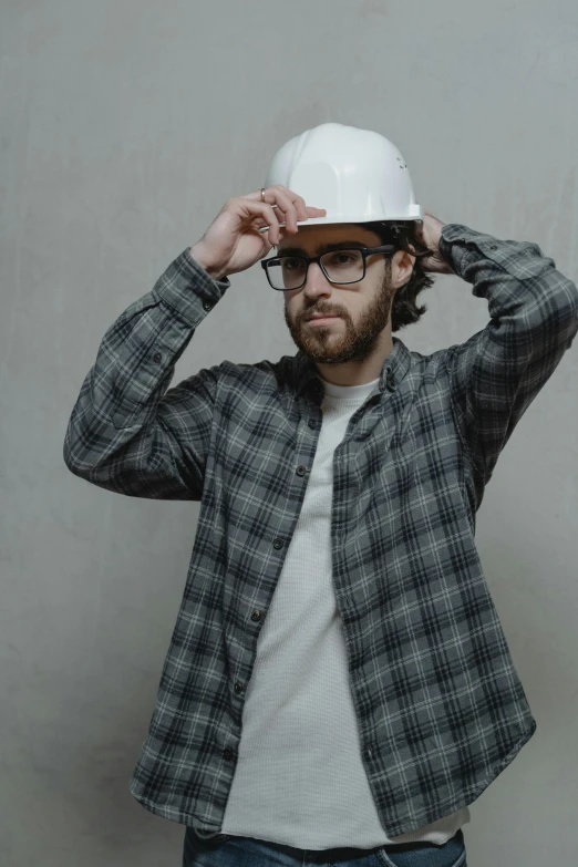 a man wearing a hard hat and glasses, a colorized photo, pexels contest winner, renaissance, model pose, charlie day, grey, gif