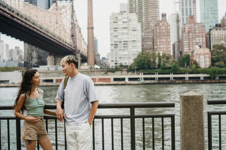 a couple standing next to each other on a bridge, pexels contest winner, realism, new york backdrop, stephen shore & john j. park, pete davidson, a blond