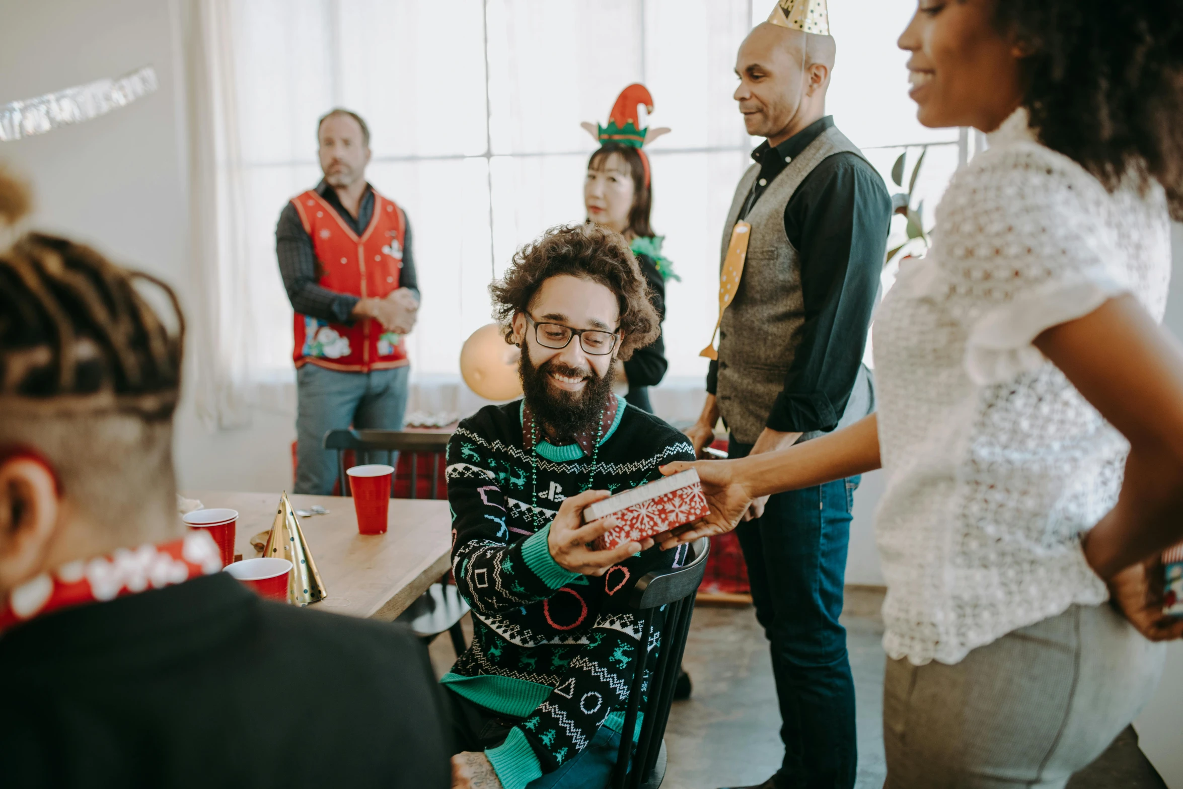 a group of people standing around a table, pexels contest winner, wearing festive clothing, smiling man, supportive, avatar image