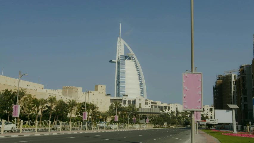 a city street with a tall building in the background, hurufiyya, sheik mohammad ruler of dubai, vacation photo