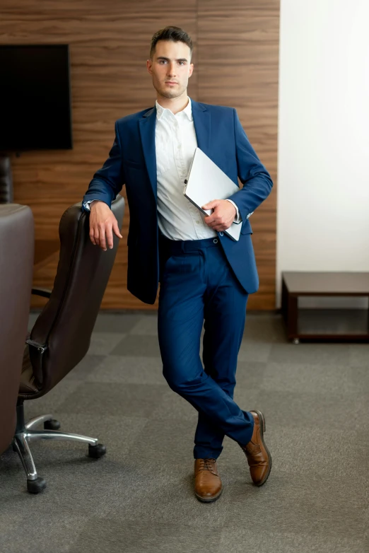 a man in a blue suit standing in an office, pexels, renaissance, young man with short, wide full body, hip corporate, lawyer