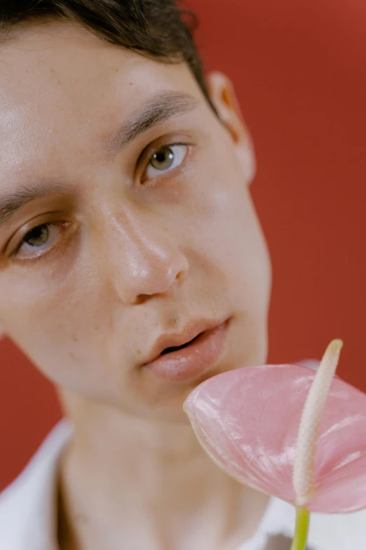 a close up of a person holding a flower, inspired by Yanjun Cheng, eating ice cream, non binary model, sweaty meat, looking to camera