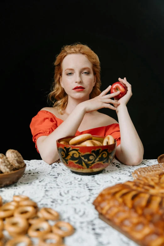 a woman sitting at a table with a bowl of food, a portrait, inspired by Lucas Cranach the Elder, pexels, renaissance, jessica chastain, square, anna nikonova aka newmilky, with apple