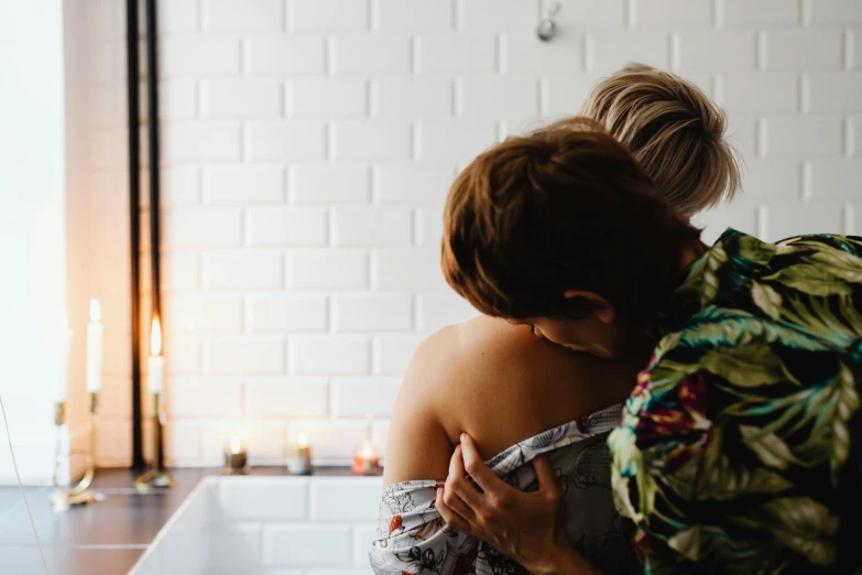 two women hugging each other in a bathtub, trending on pexels, standing with her back to us, holding a candle, couple on bed, full of details